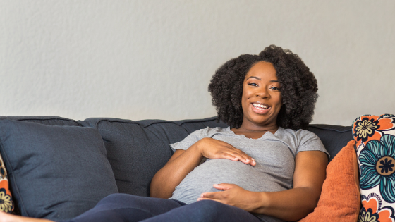 pregnant African American woman on couch